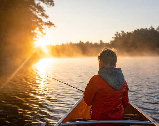 Boy fishing on kayak